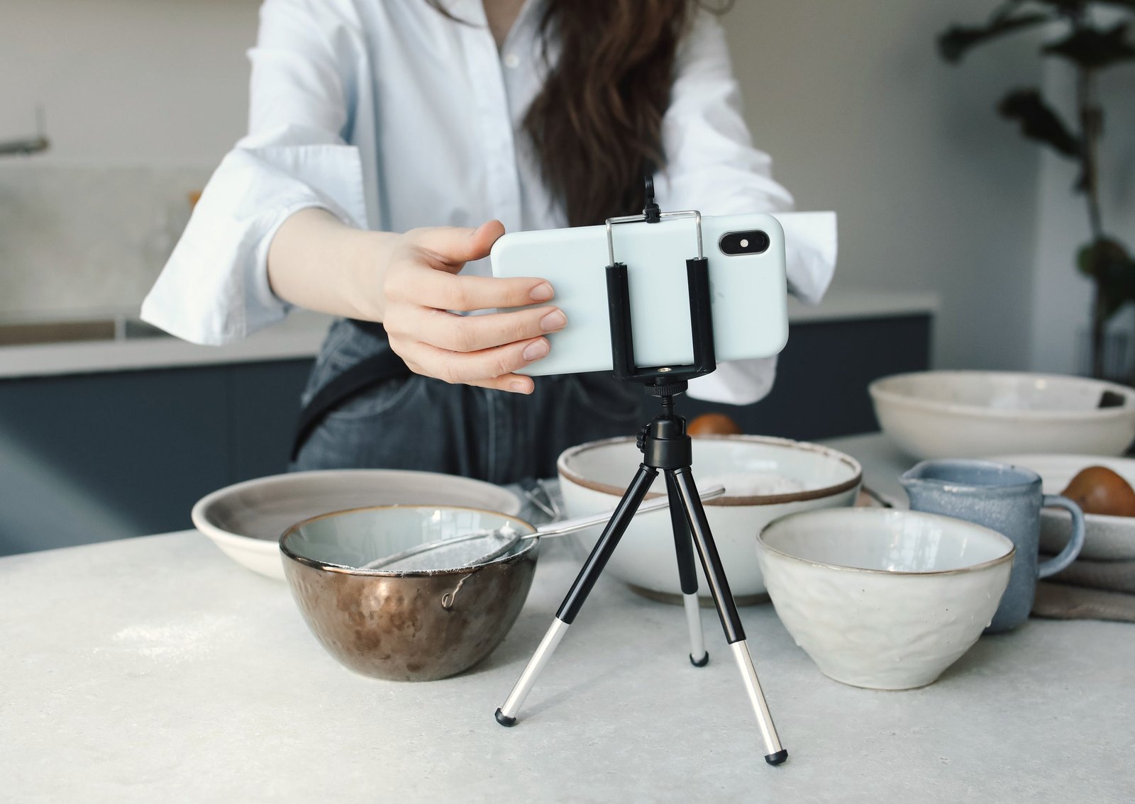 Setting up a phone on a tripod to film food being prepared.